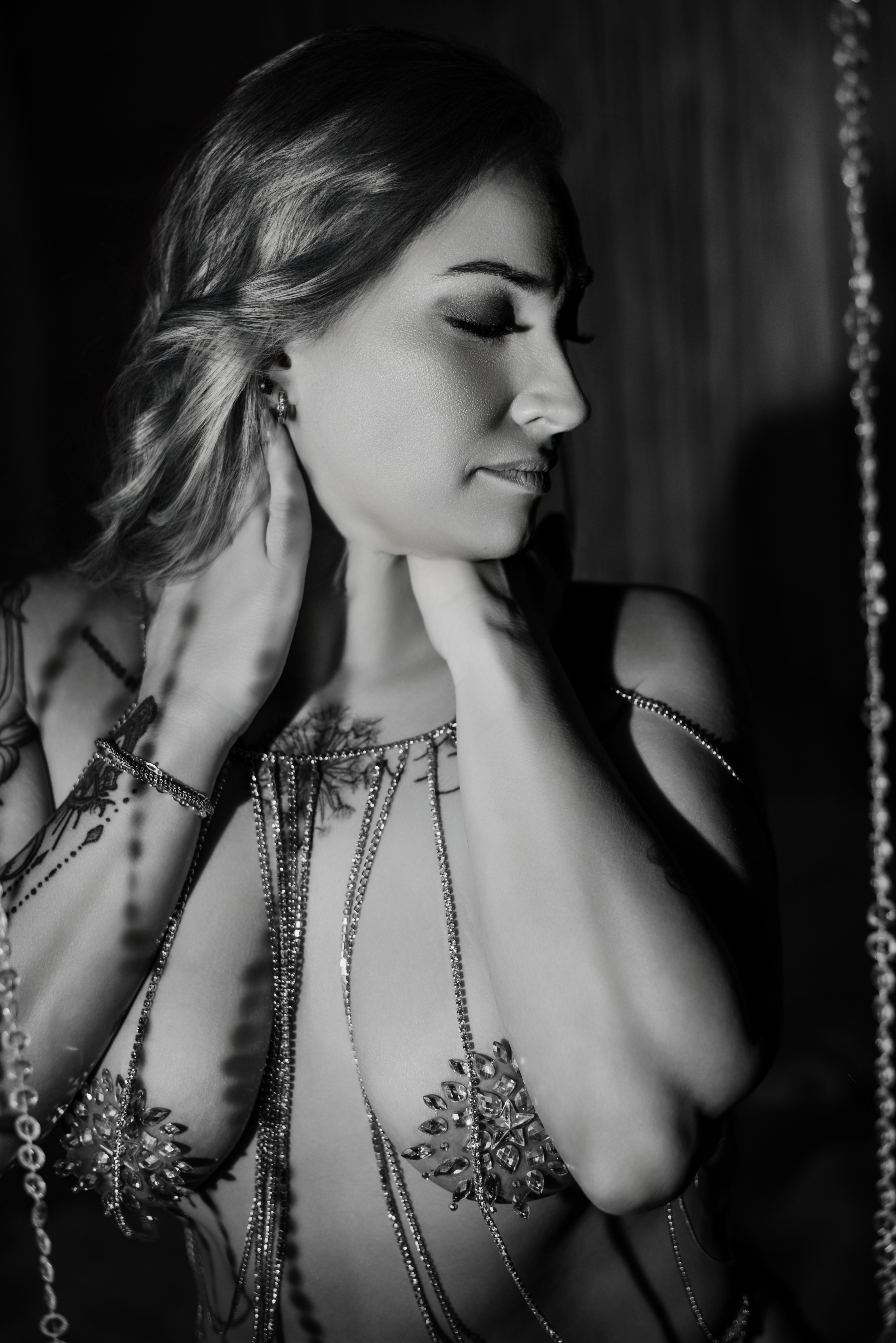 Luxury boudoir portrait featuring woman in delicate body chain jewelry.