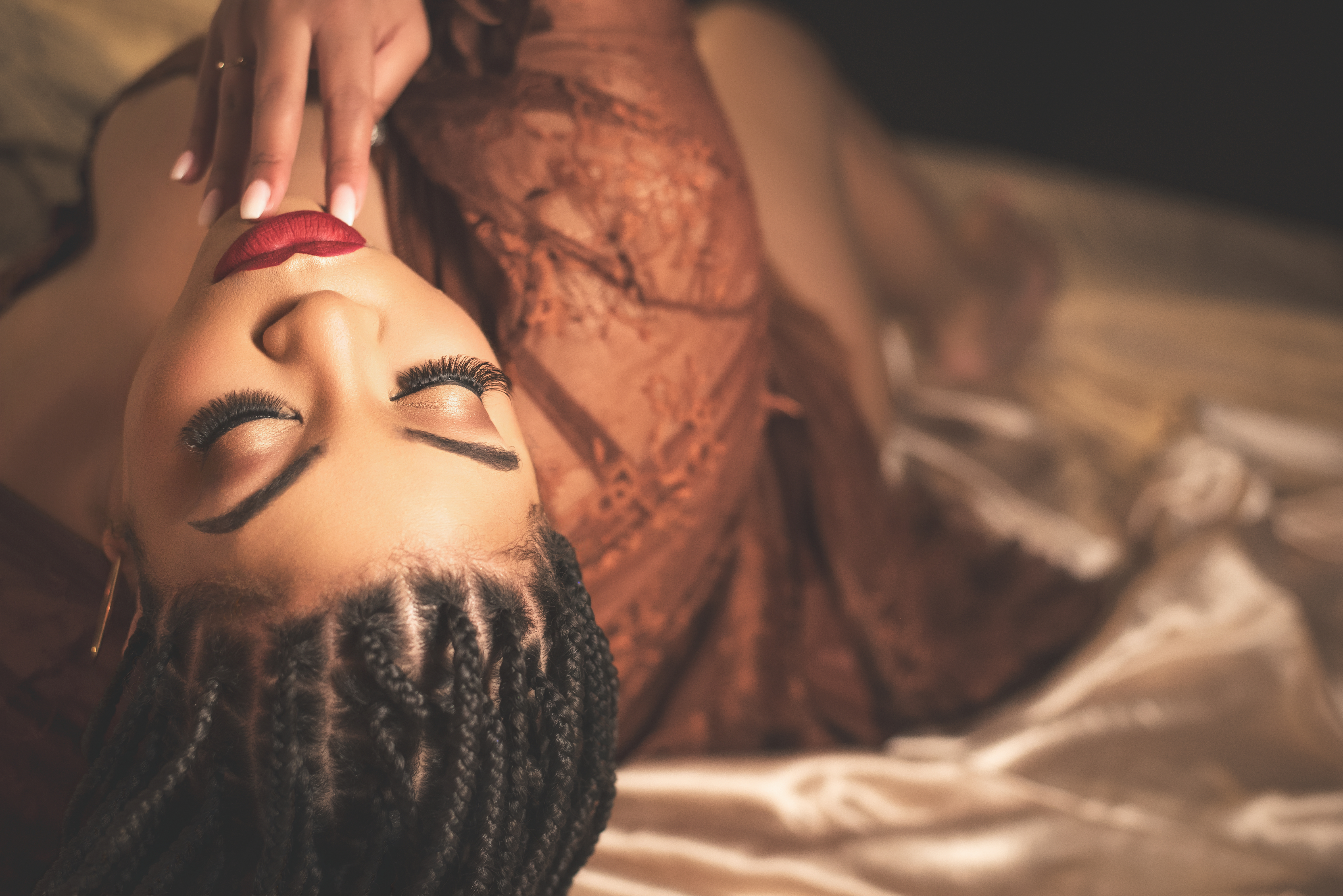 Artistic boudoir photo of woman wearing soaked sheer gown for sensual wet look