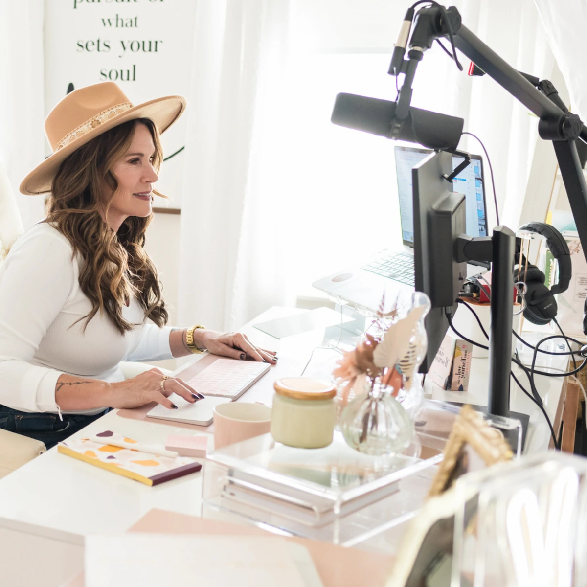 Trish Ware smiling while seated at her desk in her home office.