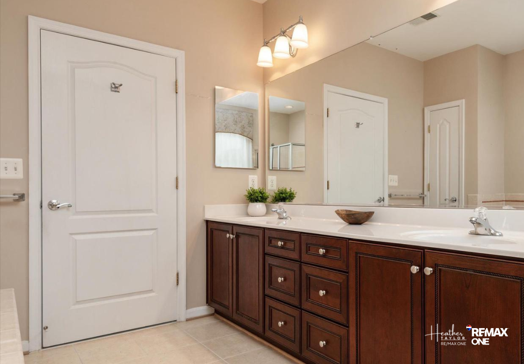 Primary bathroom with soaking tub and double vanity in Cedar Ridge home Primary bathroom with soaking tub and double vanity in Cedar Ridge home