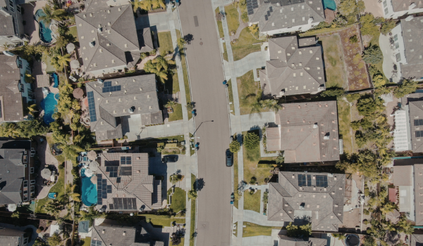 Real estate agent reviewing recent home sales data to determine property value Real estate agent reviewing recent home sales data to determine property value