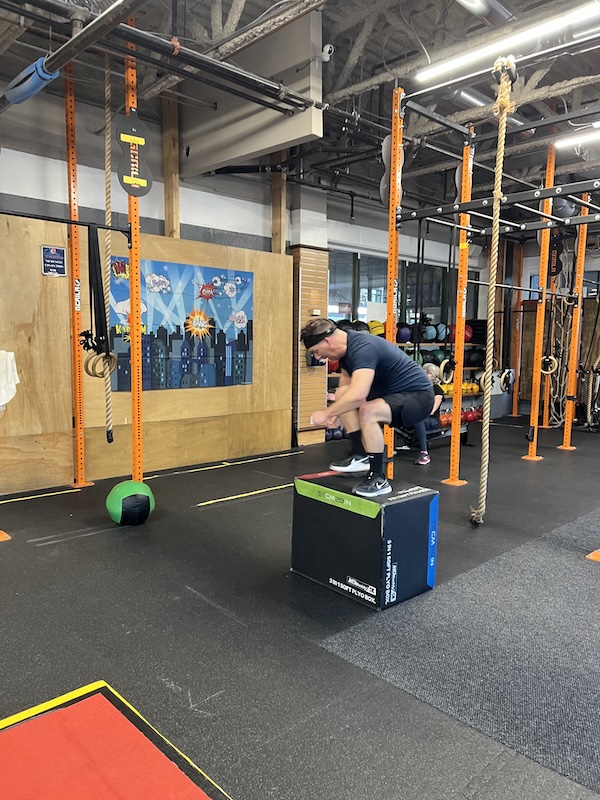 Empower athlete doing a box jump over