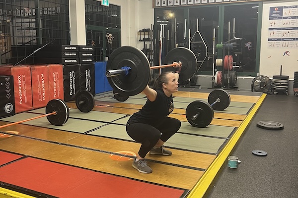 Empower member Hard Rock doing an overhead squat