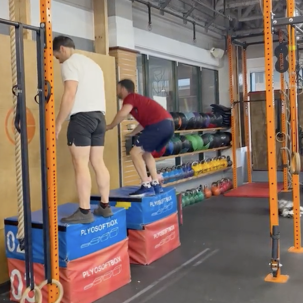 Two Empower athletes doing box jumps