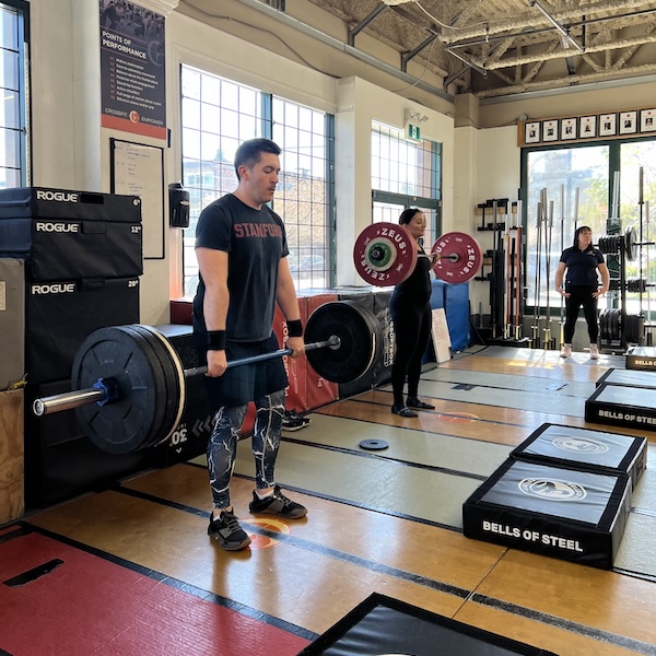 Empower member doing barbell lifts in the gym