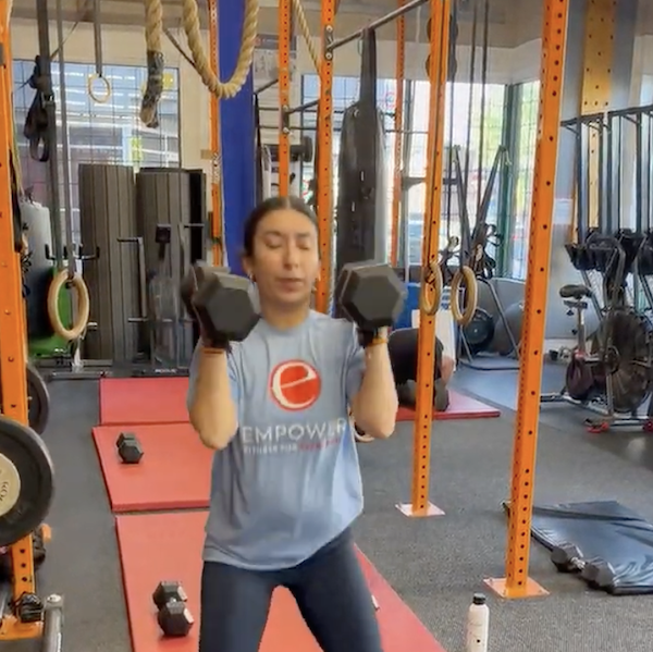 Empower member Rockstar with dumbbells