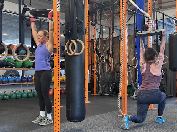 CrossFit group class overhead plate carry CrossFit group class overhead plate carry