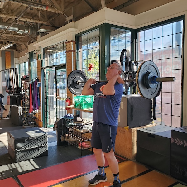 Empower member Auto doing an barbell lift
