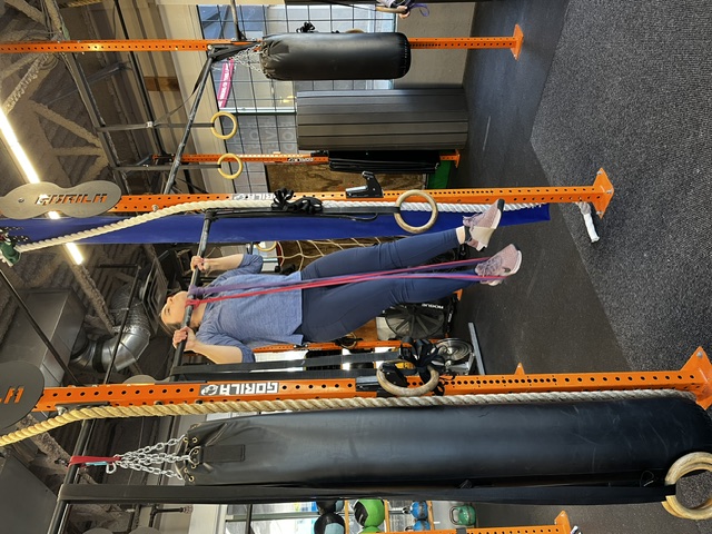 Empower member doing banded pull ups