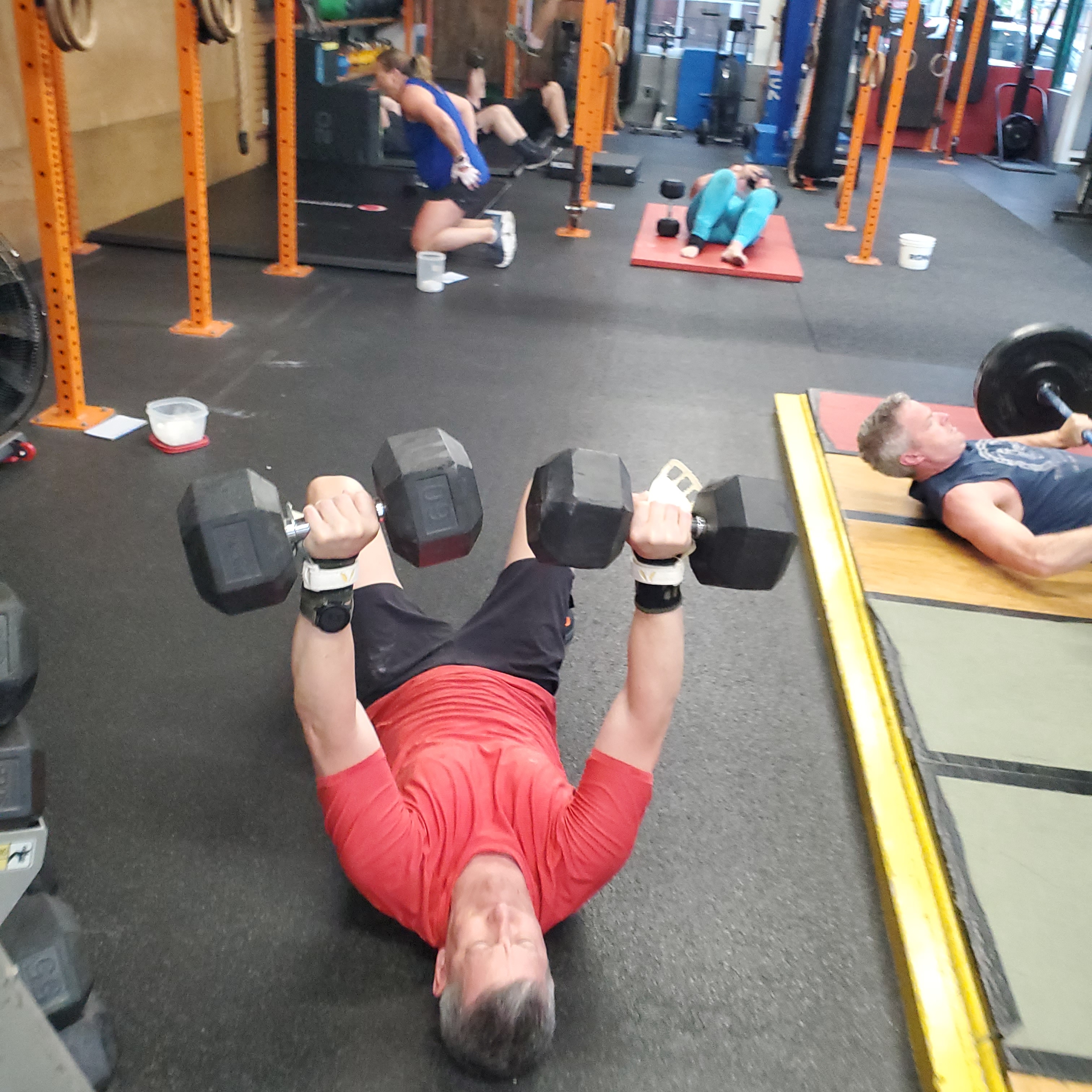 Empower athlete doing a dumbbell floor press Empower athlete doing a dumbbell floor press