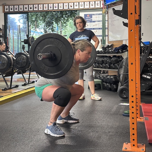 Member DT doing a back squat Member DT doing a back squat