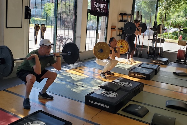 Empower members doing barbell lifts