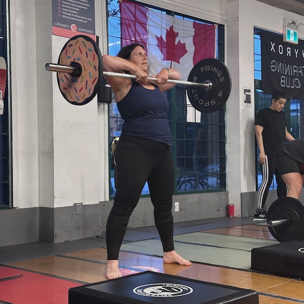 Empower member Dauntless doing a Sumo Deadlift High Pull in CrossFit group class