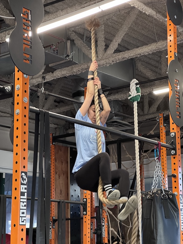 Rope climb during a CrossFit class Rope climb during a CrossFit class