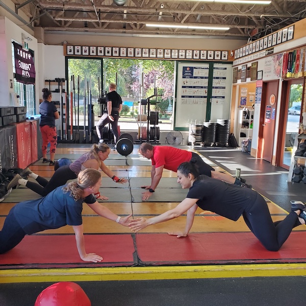 Plank holds with partner at CrossFit on Alma