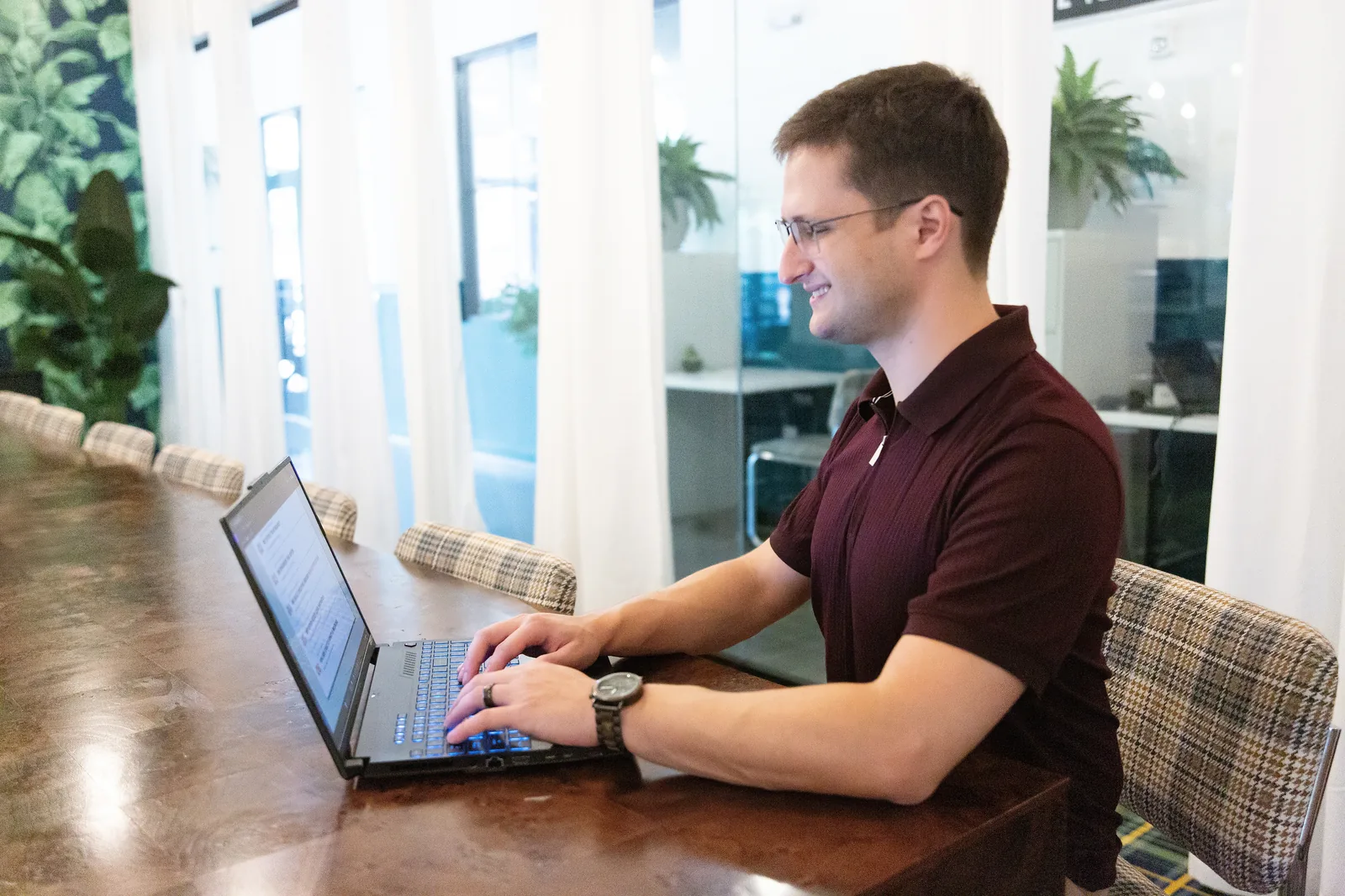 Sam Ackerman reviewing campaign performance on a laptop at the Engage Ads office in Suwanee, Georgia.
