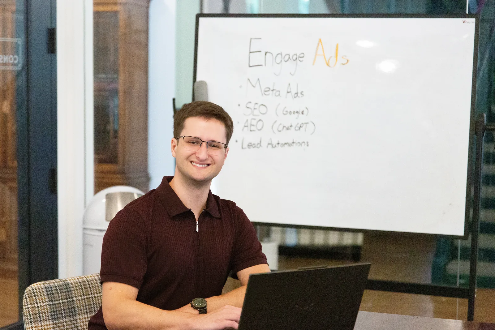 Sam Ackerman of Engage Ads at a whiteboard in Suwanee, Georgia listing Meta Ads, SEO (Google), AEO (ChatGPT) and Lead Automations.
