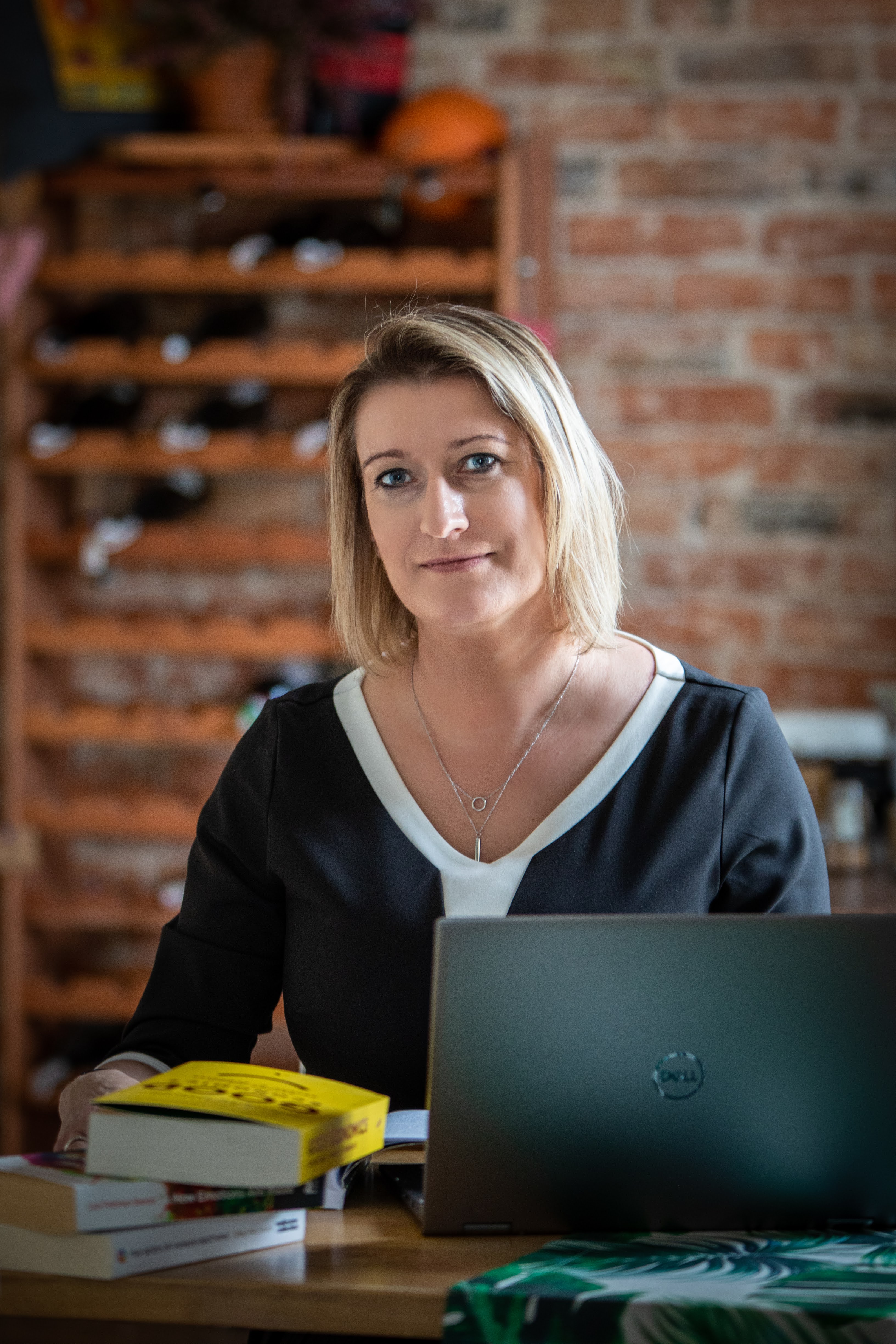 Monika Karolina Kosiedowska working with books and a laptop