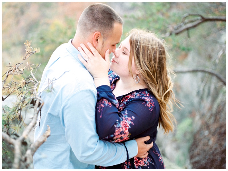 Engaged couple embracing each out at sunset rock, chattanooga tn.