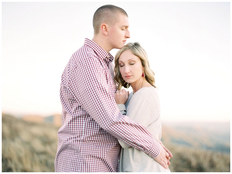 Engagement pictures of a couple together hugging on top of Roan Mountain TN.
