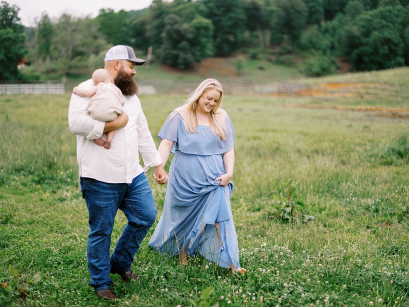 Family photo of mom, dad, and baby outdoors in Northeast Tennessee during the best time of year for family photos Family photo of mom, dad, and baby outdoors in Northeast Tennessee during the best time of year for family photos