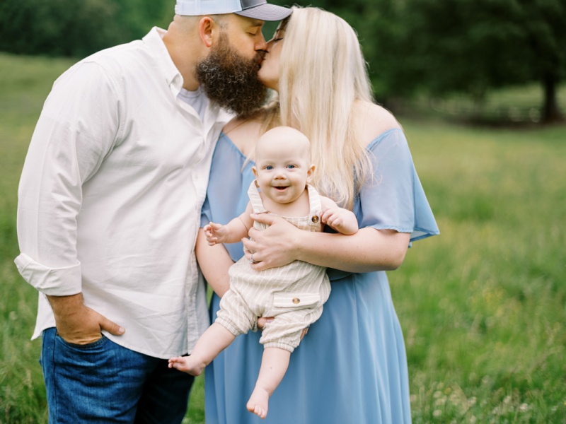 Mom, dad, and baby posing together for family photography in Northeast Tennessee at the best time of year for photos Mom, dad, and baby posing together for family photography in Northeast Tennessee at the best time of year for photos