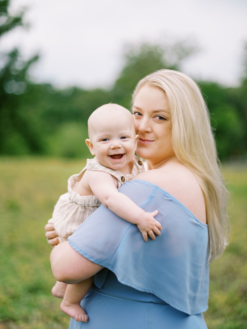 Candid family photo of parents and baby enjoying the outdoors in Northeast Tennessee at the best time of year for family photos Candid family photo of parents and baby enjoying the outdoors in Northeast Tennessee at the best time of year for family photos