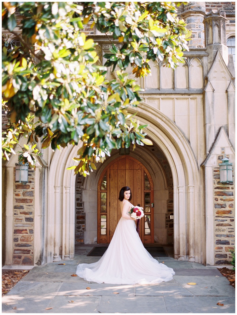 Bride in wedding dress walking near Duke University Chapel during summer photo session