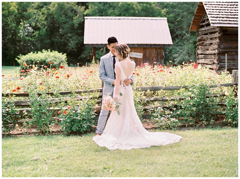 Bride and groom standing in front of wild flowers, Greeneville TN