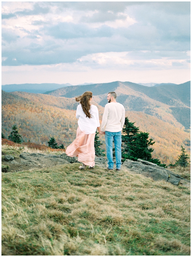Engaged couple hiking together at Roan Mountain TN during their engagement session