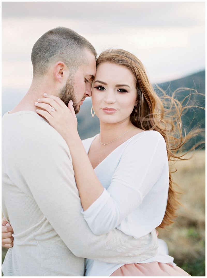 Kala smiling at Josh during outdoor engagement session in Roan Mountain TN