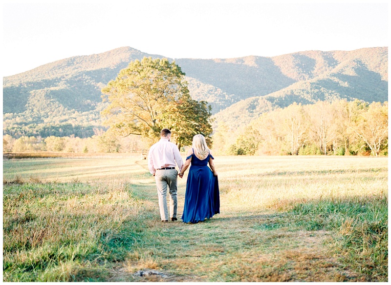 Engaged woman standing in scenic fields at Cades Cove