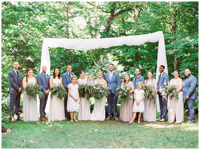 Bridal party wearing blue suits and bridesmaids wearing pink dress at their Jonesborough TN wedding