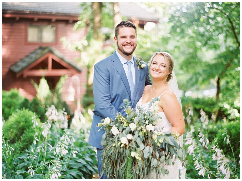 Bride and groom holding hands in outdoor wedding portraits