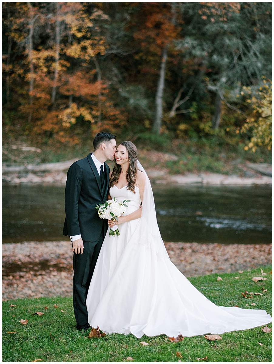 Groom kissing bride after ceremony
