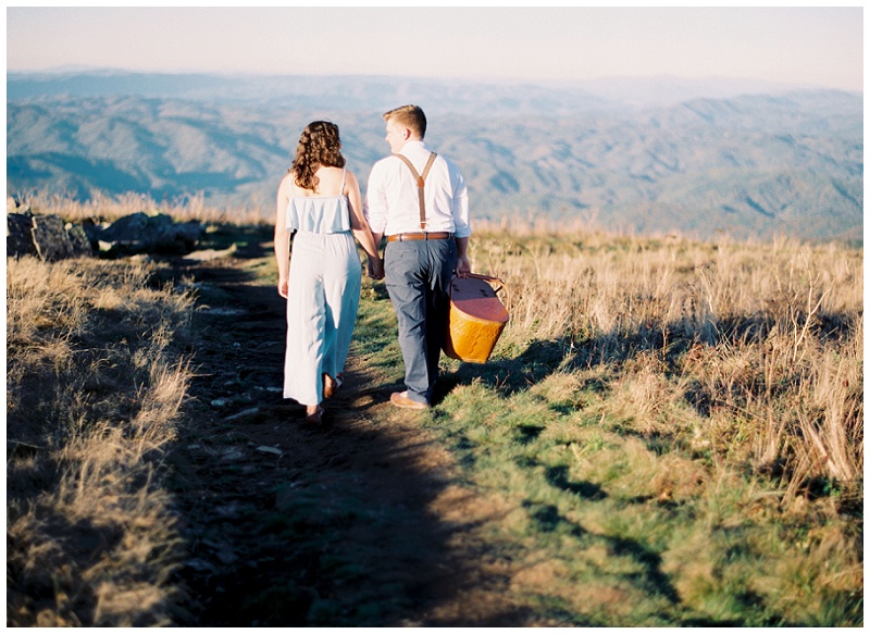 Engagement couple sitting on blanket for picnic photos