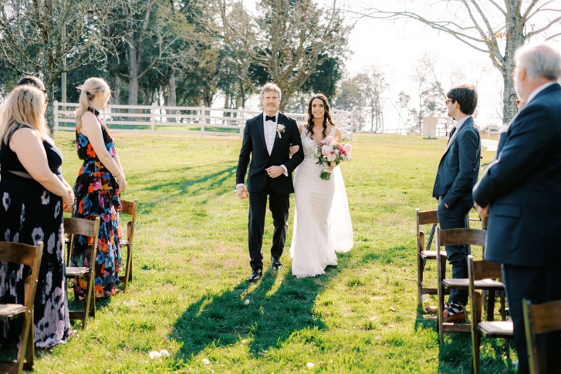 Bride walking down aisle with parents