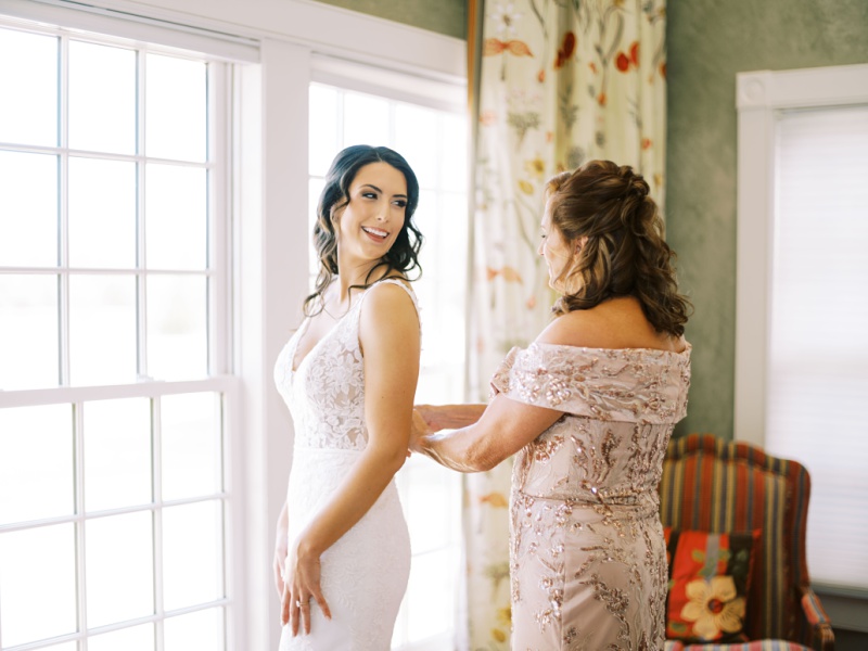 Bride putting on wedding dress at Marblegate Farm