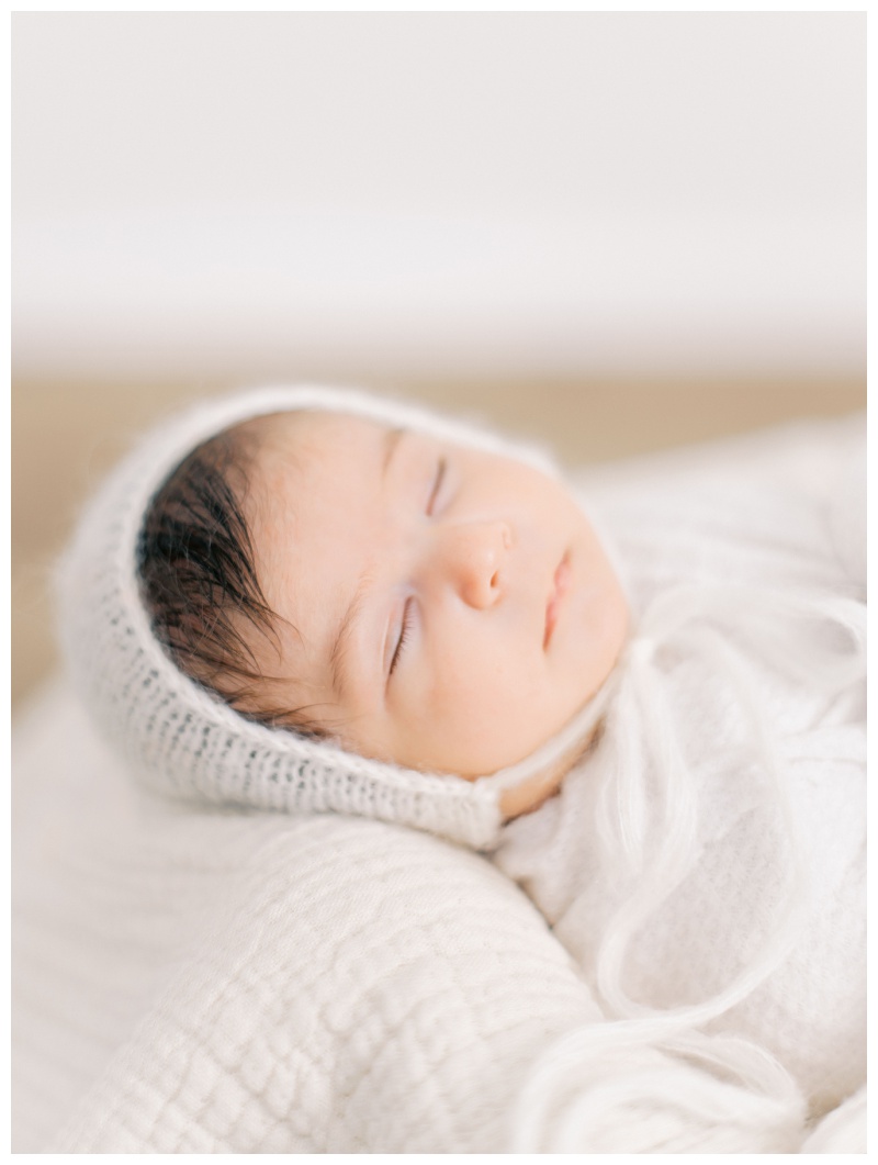 Newborn’s delicate eyelashes captured in soft studio lighting