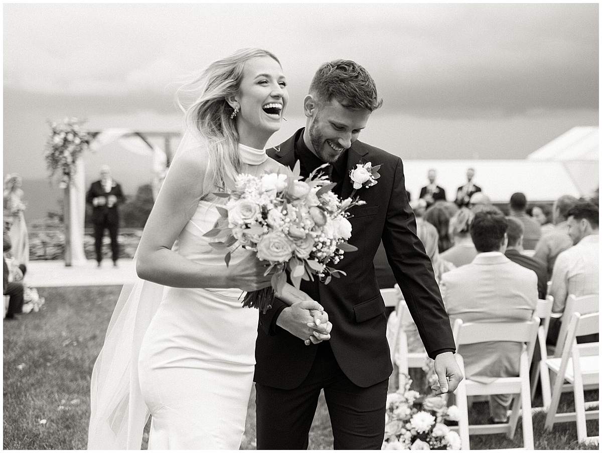 bride and groom rejoicing after wedding ceremony at overlook barn