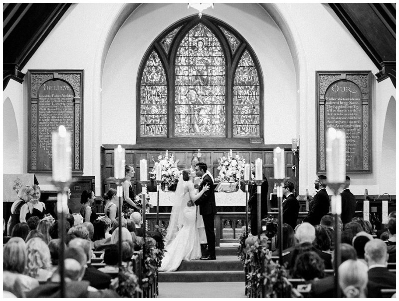 altar ceremony moment bride and groom kissing 