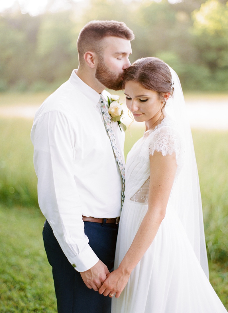 Madison and Tyler in barn Hidden Meadows wedding
