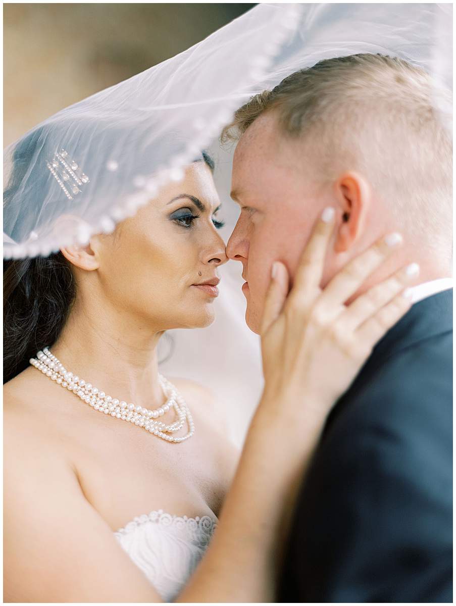 bride and groom kissing historic train station