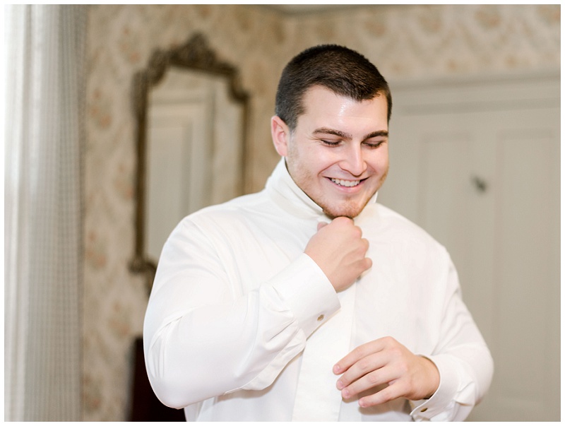 groom tying tie rustic barn wedding Tennessee