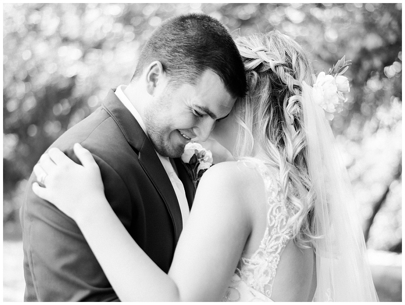 bride and groom laughing rustic barn wedding