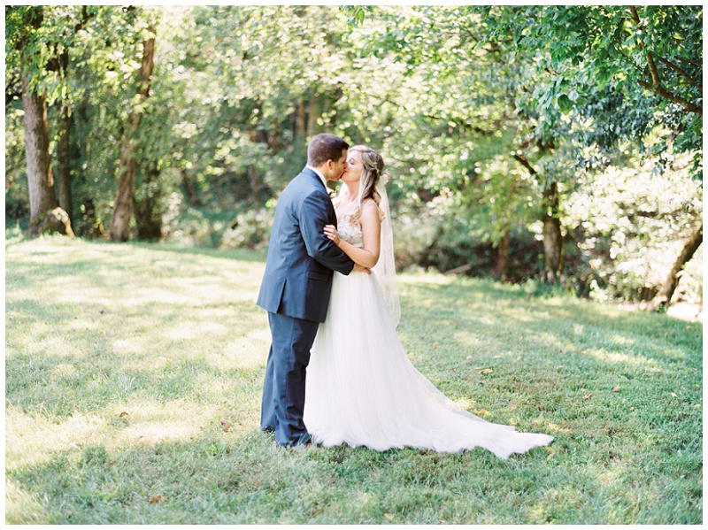 bride and groom embrace East Tennessee field