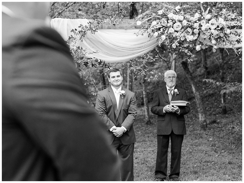 groom watching bride walk down the aisle at their rustic barn wedding Tennessee