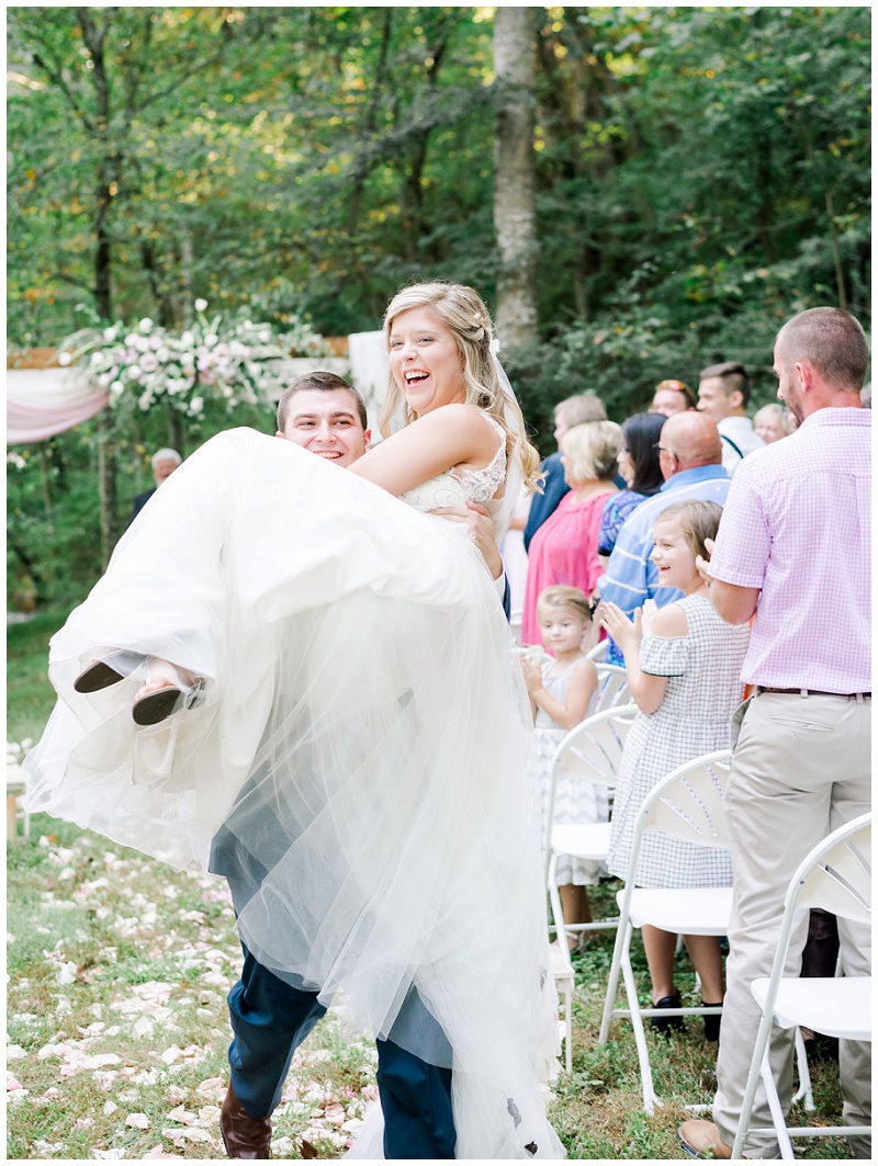 joyful wedding ceremony exit from the bride and groom at their Tennessee barn wedding