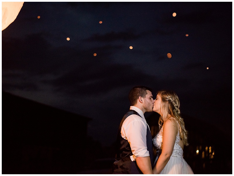 married couple kissing under their glowing lantern send off East Tennessee wedding