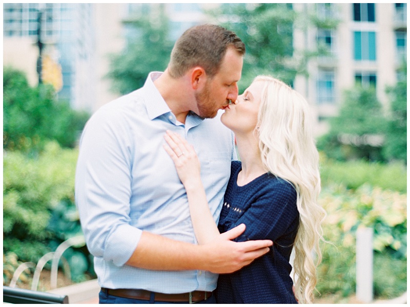 uptown charlotte nc engagement session couple walking city streets